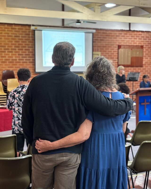 Picture of a mature couple with arms around each other listing to a Sermon at Providence Reformed Baptist Church