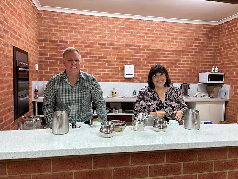 Man and woman tending the kitchen for morning tea at Providence Reformed Baptist Church